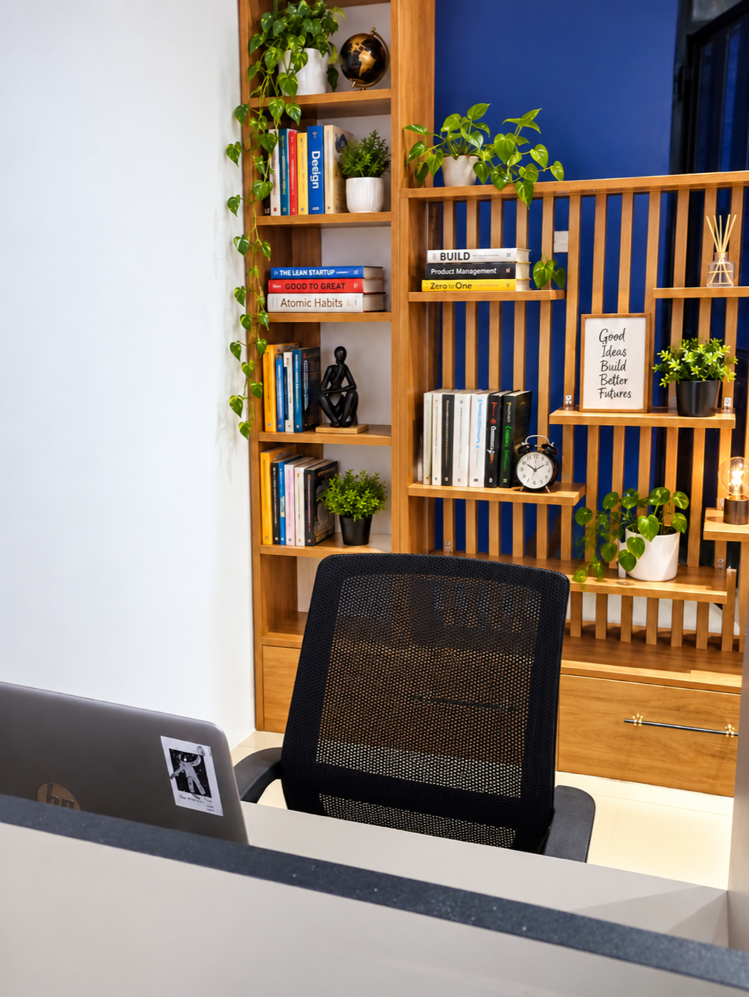 Shared workspace beside a bookshelf at Dynamic Coworking Spaces
